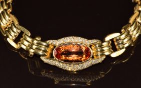 An 18ct gold necklace / necklet set with an oval cut golden topaz of approximately 29ct with 86