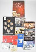 A collection of battle / war / aircraft related collectible coins in presentation packs, includes