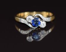 An 18ct gold ring set with a sapphire and diamonds in a platinum twist setting, 2.2g, size K