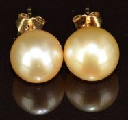 A pair of 18k gold earrings, each set with a cultured pearl