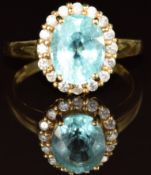 An 18k gold ring set with an oval cut paraiba tourmaline of approximately 2.9ct surrounded by