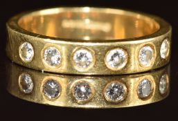 An 18ct gold half eternity ring set with six round cut diamonds, 4.8g, size K