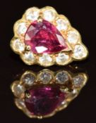 An 18ct white gold earring set with a pear cut ruby of approximately 0.25ct surrounded by