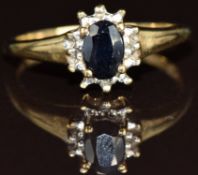 A 9ct gold ring set with an oval cut sapphire and two diamonds, 2.1g, size N