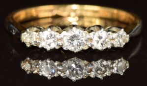 An 18ct gold ring set with five diamonds in a platinum setting, 2.8g, size N