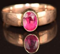 A 9ct rose gold ring set with an oval cut synthetic ruby, 2.4g, size O