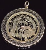 A 14k gold pendant in the form of a dragon and phoenix, with pierced border, 12.4g, 4.3cm