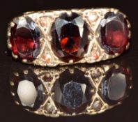 A 9ct gold ring set with garnets, 5.3g, size L