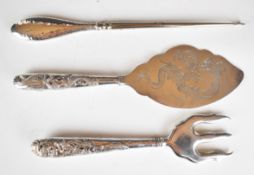 Chinese silver toasting fork and serving slice both decorated with dragons, together with a