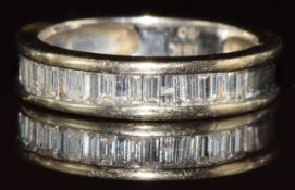 An 18ct white gold half eternity ring set with baguette cut diamonds, the total diamond weight 0.