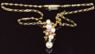 An 18ct gold pendant set with cultured pearls and diamonds in an abstract design, the total