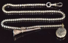 A yellow metal Albert / watch chain (testing as 9ct) with locket and watch key set with banded