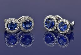A pair of 18ct white gold earrings each set with two round cut sapphires of approximately 0.5 & 0.