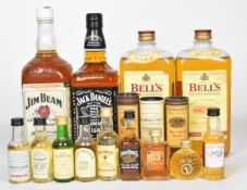 Four bottles of Scotch and Bourbon whiskys comprising Bell's, Jack Daniel's and Jim Beam together