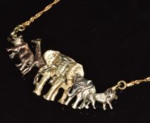 A 9k gold tri-coloured pendant in the form of an elephant, lion, giraffe and rhino, 6.7g, 44cm long