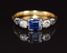 An 18ct gold ring set with a sapphire and diamond in a platinum setting (one diamond missing), 2.3g,