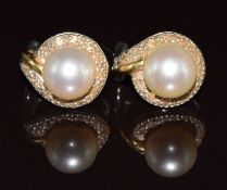 A pair of 18ct gold bi-coloured earrings each set with a pearl surrounded by diamonds, total diamond