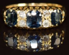 An 18ct gold ring set with sapphires and diamonds, Birmingham 1913, 4.6g, size K