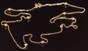 A 9ct gold necklace with beaded decoration, 7.1g, 60cm