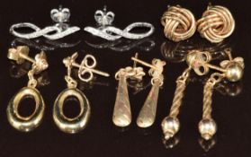A pair of 9ct white gold earrings set with diamonds (1.2g), a pair of 14k gold earrings (2.5g),