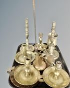A tray containing antique and later brass and copper wares including candlesticks,