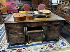 A reproduction mahogany Victorian style twin pedestal desk with a brown leather inset panel,