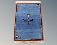 A small eastern pictorial woollen rug,