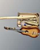 A box containing vintage brass instruments (AF), acoustic guitar and a rain stick.