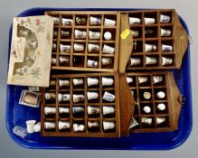 Four wooden thimble racks containing a quantity of assorted china,