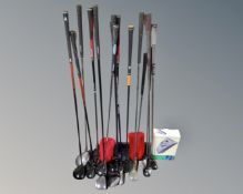 A tub containing a quantity of golf clubs, mainly drivers, including Donnay, Evolution,
