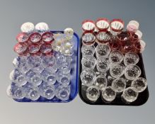 Two trays containing assorted drinking vessels including two tone wine and liqueur glasses,