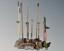 A Qualcast electric strimmer together with a quantity of garden tools.