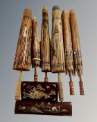 A box containing six Oriental parasols together with two wooden trinket boxes with mother of pearl