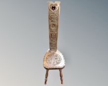 A carved oak spinning chair.