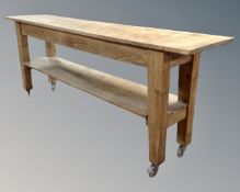 An antique pine two tier kitchen work table (length 216cm,