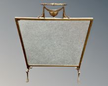A brass framed Art Nouveau fire screen with glass panel.