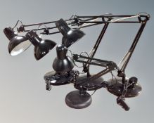 Four black angle poised table lamps.
