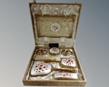 A vintage Delina eight piece dressing table set in case.