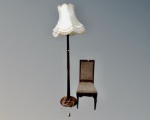 An Edwardian bedroom chair upholstered in a tapestry fabric together with a beech wood standard