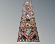 A Persian Heriz runner 85 cm x 400 cm