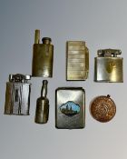 A collection of lighters including one in the form of a French 5 Franc coin.