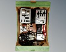 A box containing vintage cameras, digital camera, field glasses, computer accessory set in case.