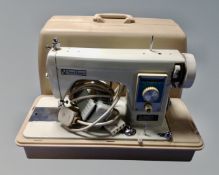 Two electric sewing machines, a Singer 377 and a New Home, both cased.