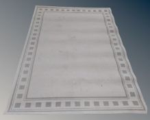 A contemporary machined rug on cream ground,