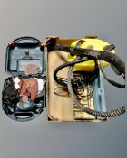 A box containing a pressure washer, Black & Decker mouse sander,