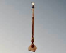 A 20th century carved oak standard lamp. CONDITION REPORT: Continental wiring.