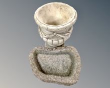 A concrete classical planter together with a stone bird bath.