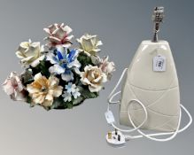 A Capodimonte porcelain basket of flowers together with a ceramic table lamp.