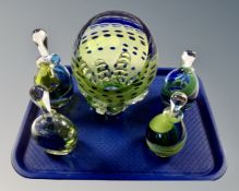 A tray of five pieces of blue and green art glass ware to include four perfume bottles with