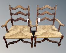 A pair of vintage continental beech rush seated open armchairs.